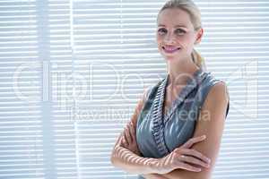 Smiling businesswoman standing in the office
