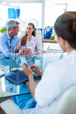 Pregnant woman and her husband discussing with doctor