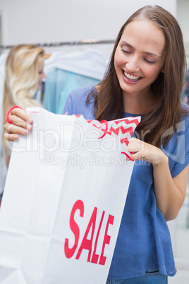Pretty brunette opening a discounted bag