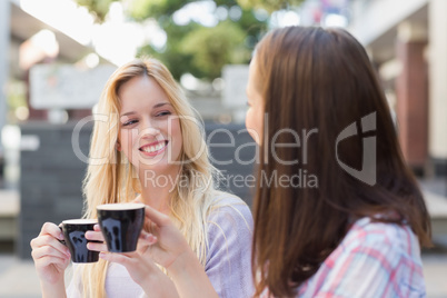 Happy women friends talking together