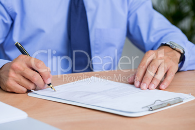Businessman signing a contract in the office