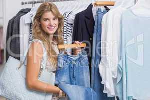 A happy smiling woman choosing some clothes
