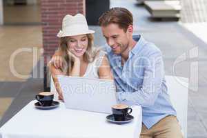 Cute couple looking at a laptop