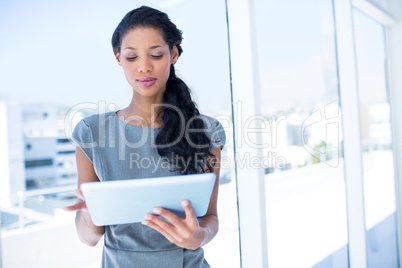 A focused businesswoman using digital tablet