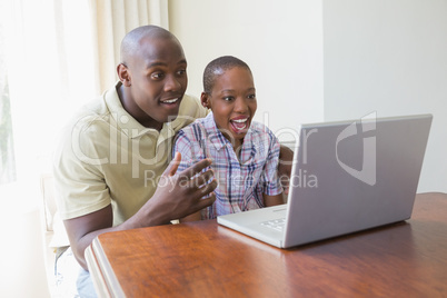 Happy smiling couple using their laptop