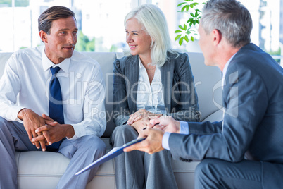 Business people speaking together on couch