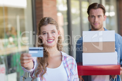 Portrait of a happy couple showing their new credit card