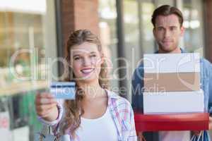 Portrait of a happy couple showing their new credit card