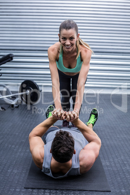 Muscular couple doing core exercises