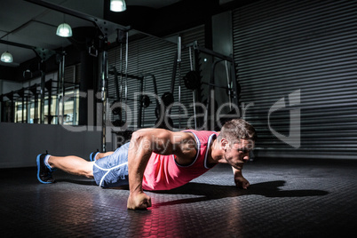 Muscular man doing push-ups