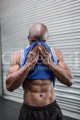 Young Bodybuilder wiping his face with his shirt