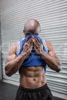 Young Bodybuilder wiping his face with his shirt