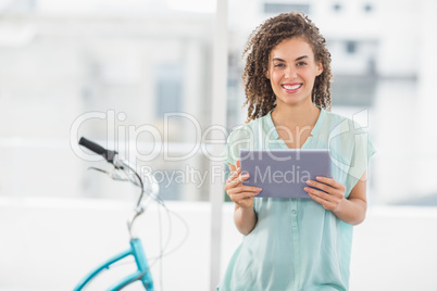 Smiling businesswoman holding a digital tablet