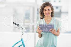 Smiling businesswoman holding a digital tablet