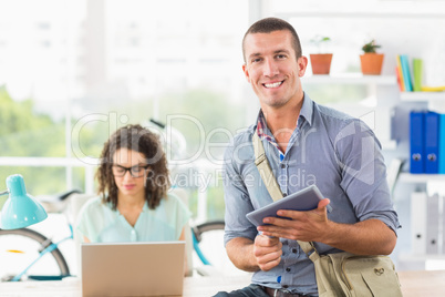 Creative businessman holding digital tablet