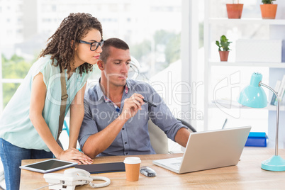 Businessman showing his work on laptop