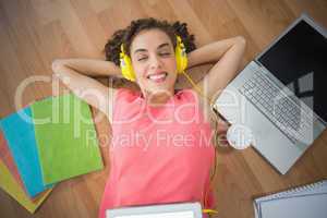 Young creative businesswoman enjoying music