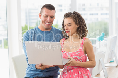 creative business colleagues holding a laptop