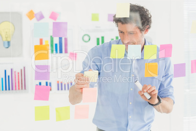 Creative businessman looking at post-it