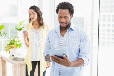 Young business people using a digital tablet and mobile phone