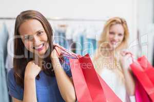 Happy friends holding shopping bags