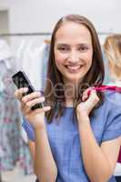 Pretty brunette holding a smartphone