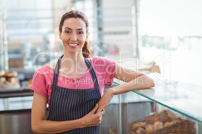 Pretty waitress leaning on counter