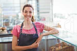 Pretty waitress leaning on counter