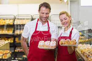 Smiling bakers having a pastry