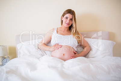 Pregnant woman looking at camera