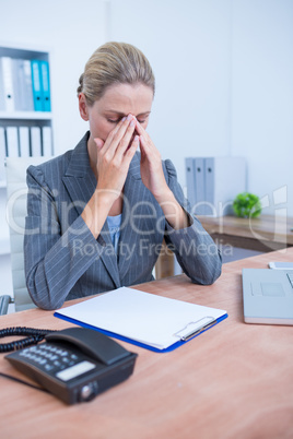 Pretty blonde businesswoman using notepad