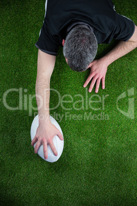 A rugby player scoring a try