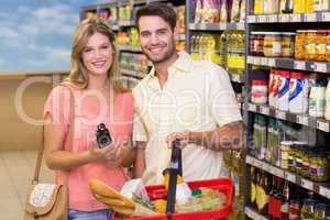Portrait of smiling bright couple buying food products using sho