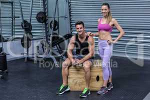 Standing and sitting muscular couple