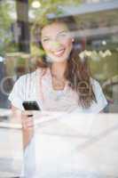 Portrait of smiling woman using smartphone