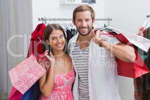 Portrait of smiling couple with shopping bags