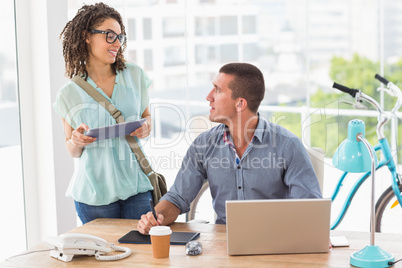 Business colleagues discussing over a graphic tablet