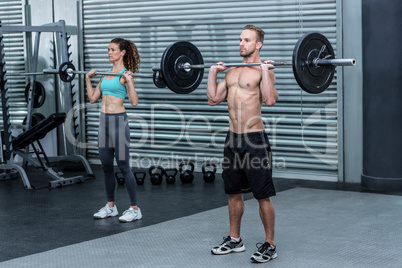 Muscular couple lifting weight together