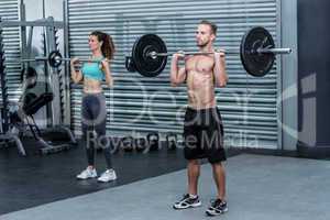 Muscular couple lifting weight together