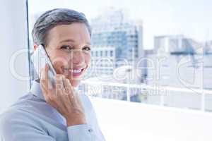 Businesswoman looking at camera while on the phone