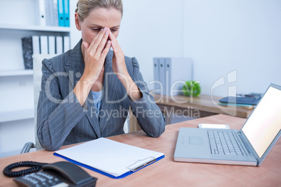 Pretty blonde businesswoman using notepad