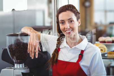 Pretty barista smiling at camera