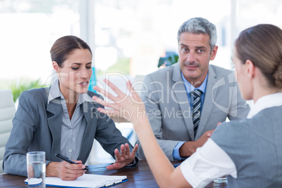 Business people interviewing young businesswoman