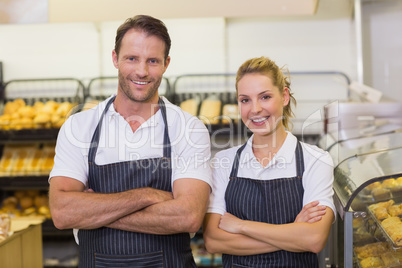 Portrait of a smiling bakers with arms crossed