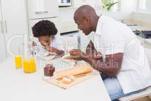 Father and son eating a breakfast