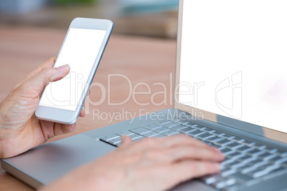 Close up view of hands typing on laptop