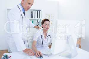 Concentrated medical colleagues working with computer