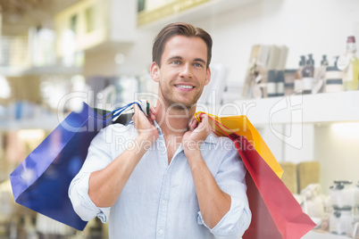 A smiling man with shopping bags