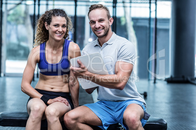 Muscular woman watching her results on clipboard