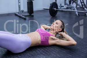 Muscular woman doing abdominal crunch